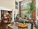 Comfortable living room with a fireplace, tall windows, and stylish decor at 1806 Pattersons Mill Rd, Durham, NC 27703