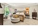 Serene main bedroom featuring a plush bed, stylish furnishings, and large windows for plenty of natural light at 1806 Pattersons Mill Rd, Durham, NC 27703