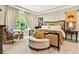 Serene main bedroom featuring a plush bed, stylish furnishings, and large windows for plenty of natural light at 1806 Pattersons Mill Rd, Durham, NC 27703