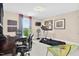 Spacious office featuring a treadmill, desk, and ample natural light, perfect for working from home and staying active at 1806 Pattersons Mill Rd, Durham, NC 27703