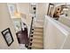 Elegant staircase with carpeted steps and white banisters, leading to the upper level of the home at 1806 Pattersons Mill Rd, Durham, NC 27703
