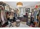 Spacious walk-in closet with custom shelving, ample storage, sitting area and natural light from the window at 1806 Pattersons Mill Rd, Durham, NC 27703