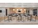 Modern bar area with marble countertops, pendant lighting, and multiple bar stools for seating at 189 Churchill Way, Clayton, NC 27520