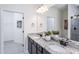 Elegant bathroom featuring double sinks with granite counters, and dark wood cabinetry with ample space at 189 Churchill Way, Clayton, NC 27520