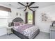 Well-lit bedroom with a gray, velvet headboard, and ceiling fan at 189 Churchill Way, Clayton, NC 27520