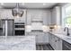 Modern kitchen features stainless appliances, subway tile backsplash, granite counters, and updated fixtures at 189 Churchill Way, Clayton, NC 27520