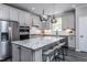 Stunning kitchen boasts stainless appliances, a granite island with bar seating, and pendant lighting at 189 Churchill Way, Clayton, NC 27520