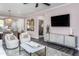 Bright, comfortable living room with stylish furniture, modern decor, and seamless flow into the dining area at 189 Churchill Way, Clayton, NC 27520