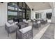 This outdoor patio features modern seating around a fire pit, with scenic views and ample space for gatherings at 189 Churchill Way, Clayton, NC 27520