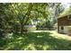 Spacious backyard featuring a lush lawn, mature trees, and a shed providing ample outdoor space at 1964 Wellington Rd, Burlington, NC 27217