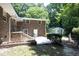 A brick home featuring a backyard with a patio, a detached garage, and ample space for outdoor activities at 1964 Wellington Rd, Burlington, NC 27217