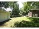 Expansive backyard featuring lush green lawn and partial fencing, offering privacy and outdoor enjoyment at 1964 Wellington Rd, Burlington, NC 27217