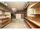 Basement with concrete floor and wooden shelves around brick walls, perfect for ample storage and organization at 1964 Wellington Rd, Burlington, NC 27217