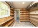 Spacious basement with built-in wooden shelves and convenient access to additional storage at 1964 Wellington Rd, Burlington, NC 27217