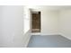 Finished basement area with neutral paint, brick detail and bright window at 1964 Wellington Rd, Burlington, NC 27217
