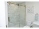 Bathroom featuring a frameless glass shower door and tiled shower at 1964 Wellington Rd, Burlington, NC 27217