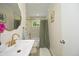 Stylish bathroom featuring a modern sink, gold fixtures, and marble-tiled shower with curtain at 1964 Wellington Rd, Burlington, NC 27217