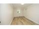 Well-lit bedroom with wood-look flooring, a window, and a convenient closet at 1964 Wellington Rd, Burlington, NC 27217