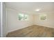 Inviting bedroom features wood-look floors, two bright windows, and a spacious closet at 1964 Wellington Rd, Burlington, NC 27217