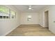 Well-lit bedroom with wood-look floors, ceiling fan and two windows at 1964 Wellington Rd, Burlington, NC 27217