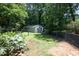 Backyard with a view of the detached garage featuring ample green space and privacy at 1964 Wellington Rd, Burlington, NC 27217