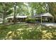 Traditional brick home with a covered carport providing convenient parking and blending seamlessly with the lush, green surroundings at 1964 Wellington Rd, Burlington, NC 27217