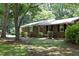 Charming brick home featuring a well-maintained lawn, classic shutters, and mature trees, offering a serene curb appeal at 1964 Wellington Rd, Burlington, NC 27217