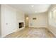 Inviting living room featuring refinished floors and a modern fireplace, creating a cozy atmosphere at 1964 Wellington Rd, Burlington, NC 27217