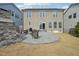 Spacious backyard featuring a stone patio, outdoor seating, and a well-maintained lawn at 1985 Firenza Dr, Apex, NC 27502