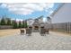 Spacious backyard featuring a stone fireplace and seating area for relaxing and entertaining at 1985 Firenza Dr, Apex, NC 27502