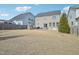 Large backyard with patio, stone fireplace, well-manicured lawn and nice view at 1985 Firenza Dr, Apex, NC 27502