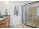 Modern bathroom featuring walk-in shower and grey tile at 1985 Firenza Dr, Apex, NC 27502