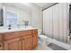 Cozy bathroom featuring a wooden vanity, combined tub and shower, and modern fixtures at 1985 Firenza Dr, Apex, NC 27502