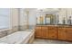 Bathroom featuring large tub and double sink vanity at 1985 Firenza Dr, Apex, NC 27502