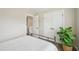 Bright bedroom featuring wood floors, modern doors and a large decorative plant at 1985 Firenza Dr, Apex, NC 27502
