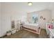 Bright bedroom featuring a window, coordinated decor, and hardwood floors at 1985 Firenza Dr, Apex, NC 27502