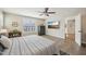 Bedroom featuring wood floors, neutral paint, ceiling fan and television at 1985 Firenza Dr, Apex, NC 27502