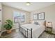 Well-lit bedroom featuring a window, modern decor, and a comfortable bed with stylish accents at 1985 Firenza Dr, Apex, NC 27502