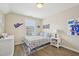 A cheerfully decorated bedroom with a bright window, hardwood floors and team-themed wall decorations at 1985 Firenza Dr, Apex, NC 27502