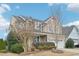 Beautiful home with manicured landscaping, mature trees, and a welcoming facade at 1985 Firenza Dr, Apex, NC 27502