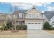 Charming two-story home featuring a manicured lawn and a two-car garage at 1985 Firenza Dr, Apex, NC 27502