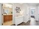 Hallway featuring hardwood floors, neutral paint, and view of bathroom and bedroom at 1985 Firenza Dr, Apex, NC 27502