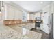 Well-equipped kitchen featuring granite countertops, stainless steel appliances, and ample cabinet space at 1985 Firenza Dr, Apex, NC 27502
