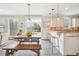 Bright eat-in kitchen boasting granite counters, pendant lights, and a seamless flow to the outdoor space at 1985 Firenza Dr, Apex, NC 27502
