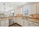 Modern kitchen featuring granite countertops, stainless steel appliances, and an open view of the dining area at 1985 Firenza Dr, Apex, NC 27502