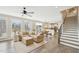 Spacious living room with a large sectional and an open view to the kitchen at 1985 Firenza Dr, Apex, NC 27502