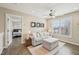 Comfortable living room featuring hardwood floors, neutral paint, and ceiling fan at 1985 Firenza Dr, Apex, NC 27502