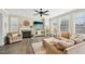 Inviting living room featuring a cozy fireplace, large windows, and comfortable seating arrangement at 1985 Firenza Dr, Apex, NC 27502