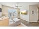 Cozy living room with neutral tones, ceiling fan, and a comfortable couch and ottoman set at 1985 Firenza Dr, Apex, NC 27502