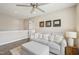 Cozy living room featuring hardwood floors, neutral paint, and ceiling fan at 1985 Firenza Dr, Apex, NC 27502
